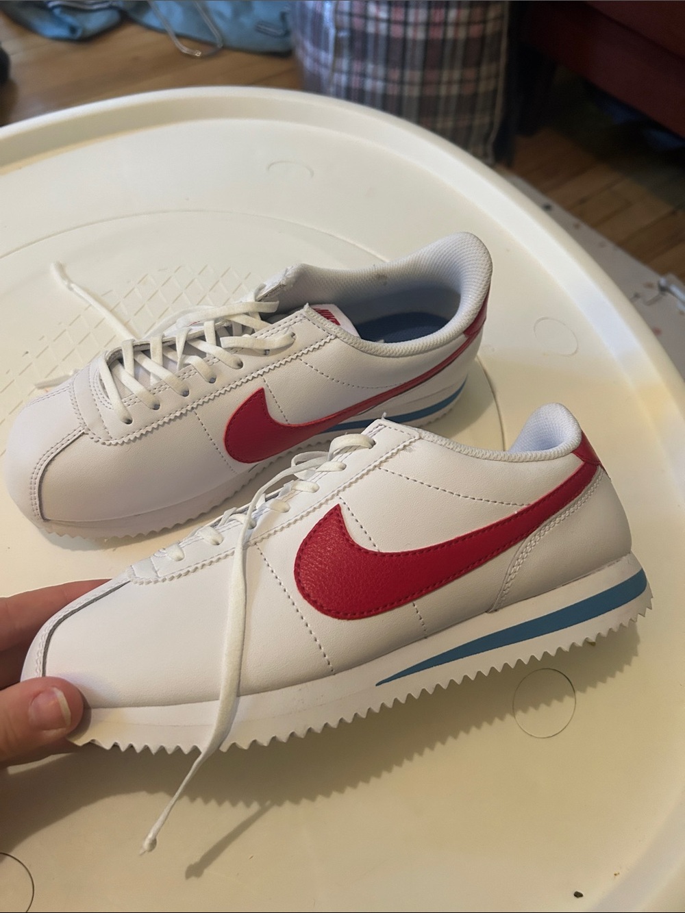 Nike Kids White Sneakers with Red Swoosh and Blue Accent